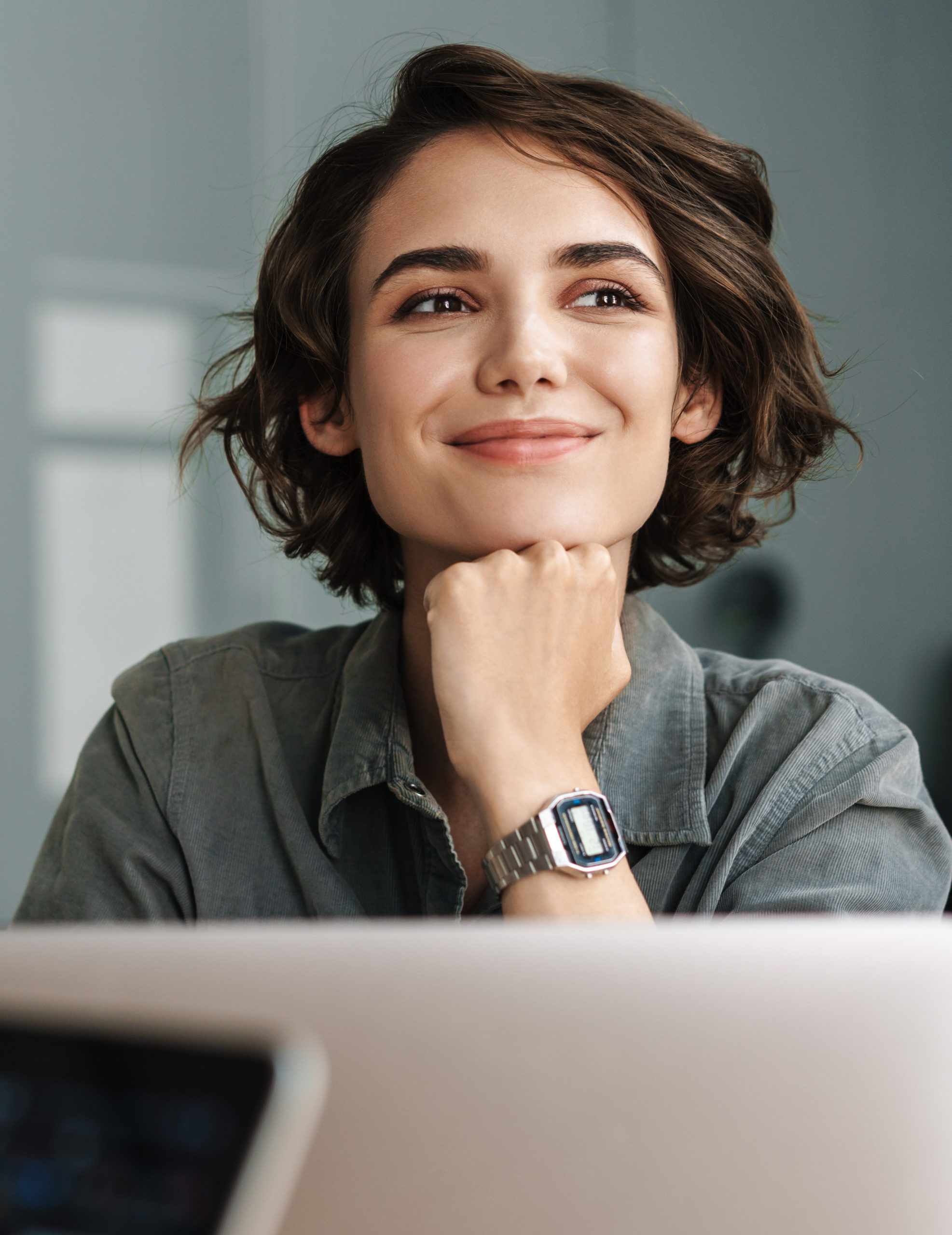 Female smiling in front of computer